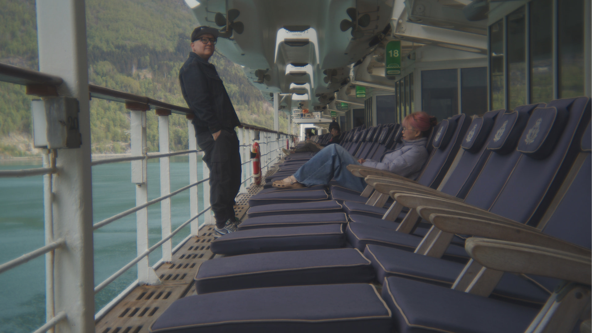 Lee and ShangTing on the promenade deck of a cruise ship at sea